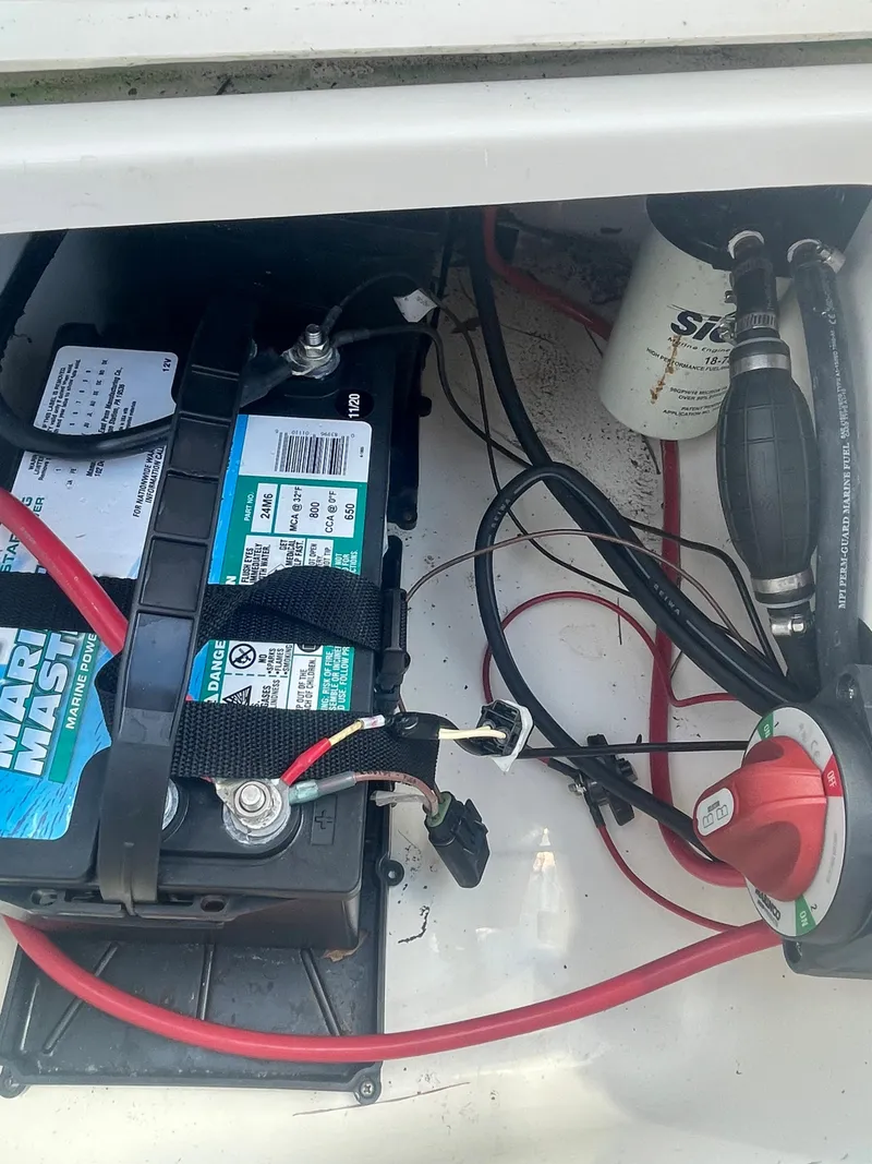 Slide: The Image of Battery compartment of a 2021 Bulls Bay 200 CC boat with wiring and fuel filter. - 16