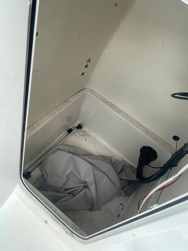 Slide: The Image of Storage compartment of a 2021 Bulls Bay 200 CC boat with wiring and cover. - 17