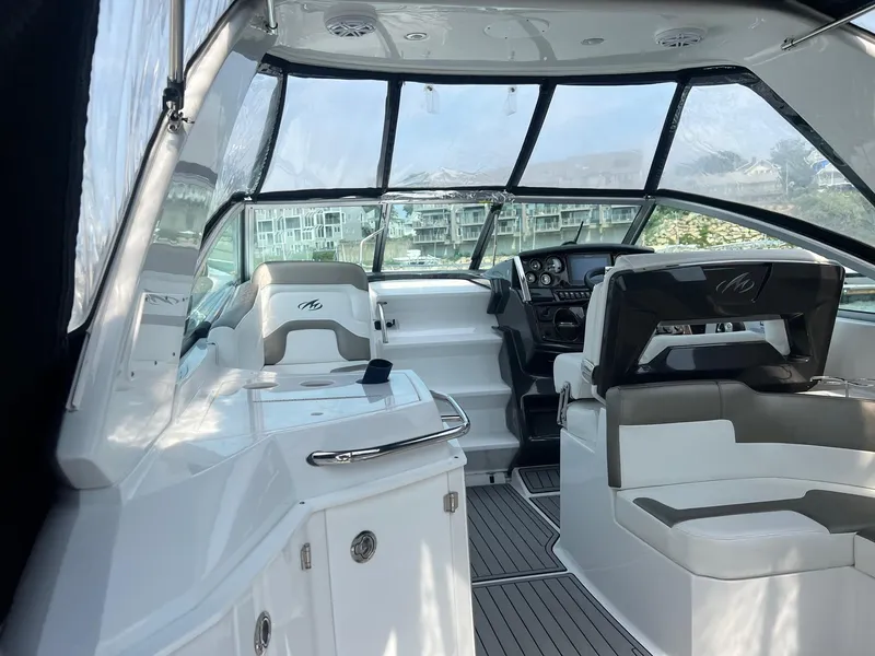 Slide: The Image of Interior of 2019 Monterey 295 Sport Yacht with modern seating and dashboard. - 10