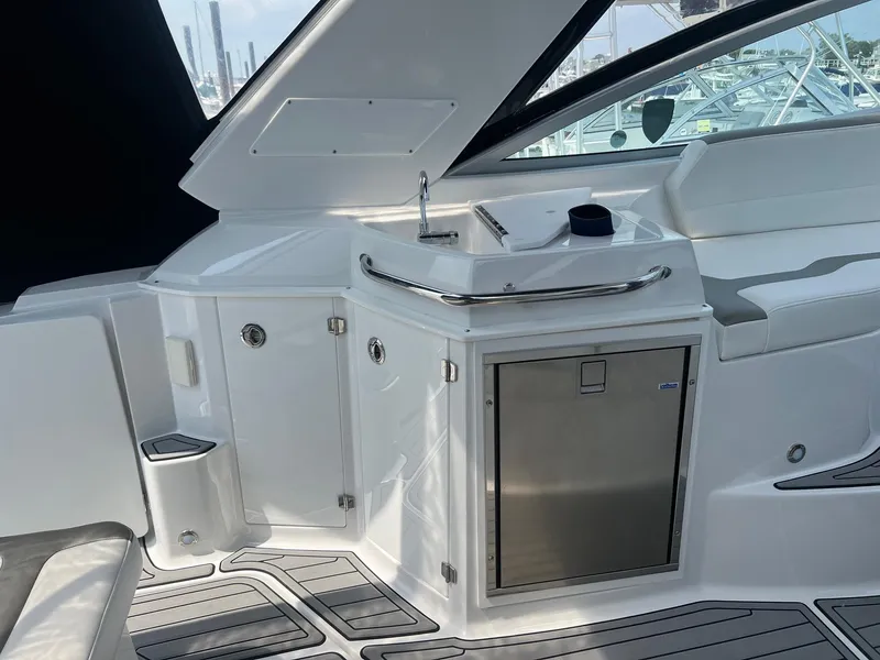 Slide: The Image of 2019 Monterey 295 Sport Yacht interior with sink and storage. - 13