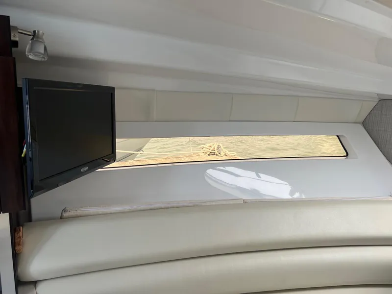 Slide: The Image of Interior of 2019 Monterey 295 Sport Yacht with TV and window. - 22