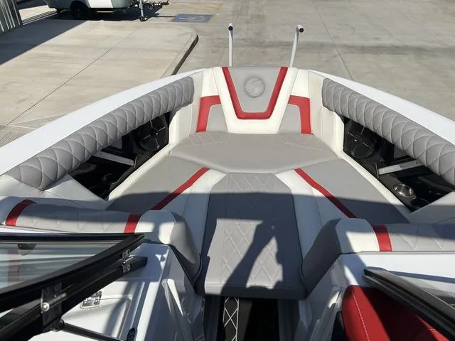 Slide: The Image of 2022 Tigé 23ZX boat interior with gray and red seating. - 10