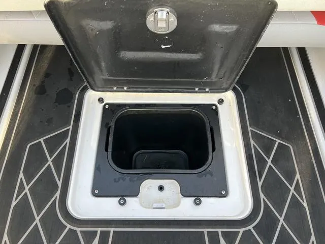 Slide: The Image of 2022 Tigé 23ZX boat storage compartment with open lid. - 13