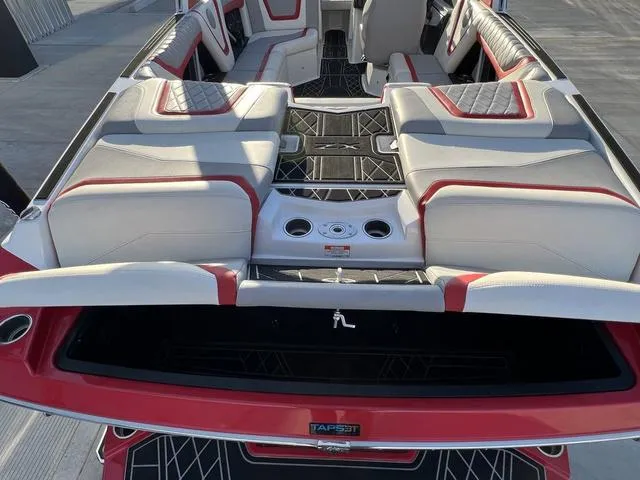 Slide: The Image of 2022 Tigé 23ZX boat interior with red and white seating and TAPS3T system. - 15