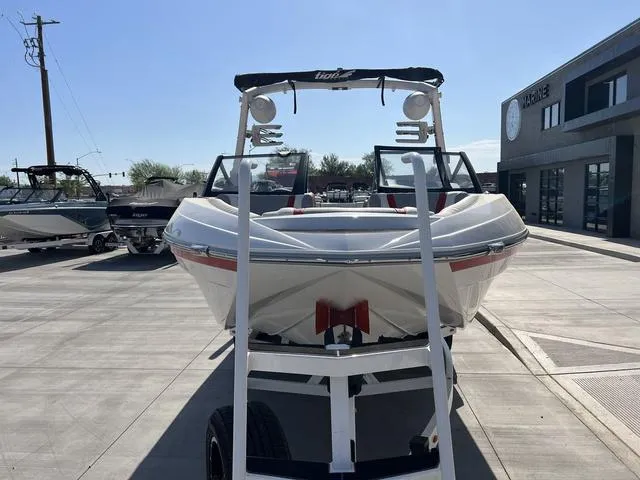 Slide: The Image of 2022 Tigé 23ZX boat on trailer in marina parking lot. - 6