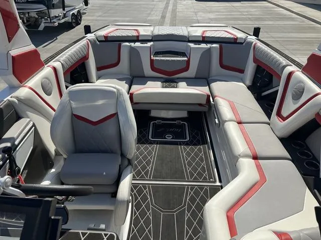 Slide: The Image of 2022 Tigé 23ZX boat interior with red and gray seating, modern design. - 7