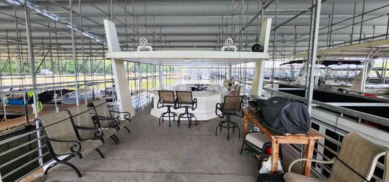 Slide: The Image of 2007 Destination Yachts 16x58 houseboat with spacious deck and seating area in marina. - 12