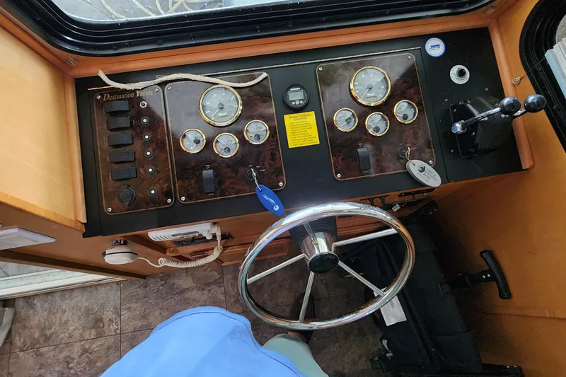 Slide: The Image of Control panel of a 2007 Destination Yachts 16x58 houseboat with steering wheel and gauges. - 21