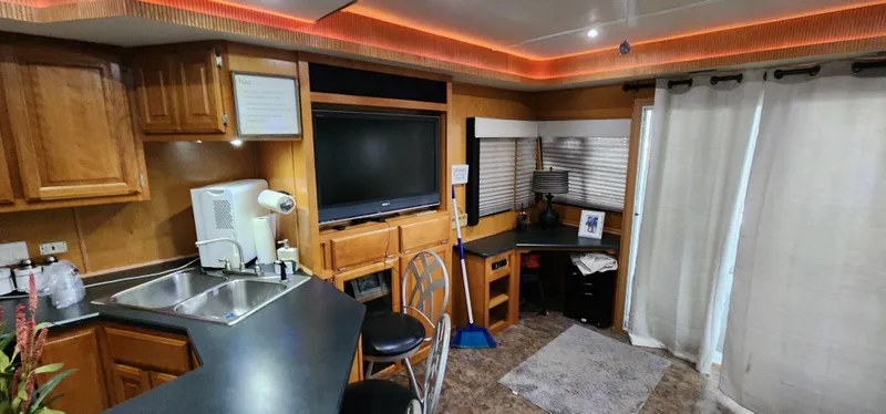 Slide: The Image of Interior of a 2007 Destination Yachts 16x58 houseboat with modern kitchen and living area. - 22