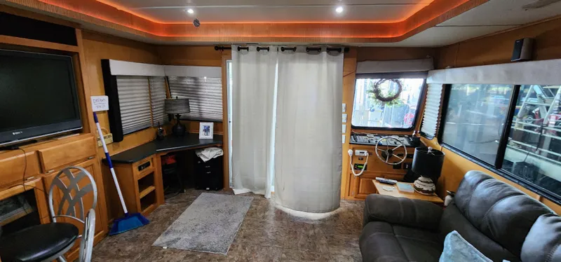 Slide: The Image of Interior of a 2007 Destination Yachts 16x58 houseboat with modern furnishings and ambient lighting. - 23