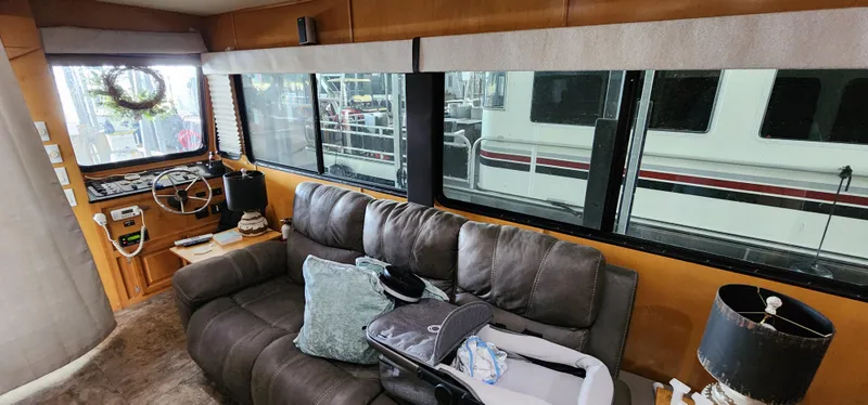 Slide: The Image of Interior of a 2007 Destination Yachts 16x58 houseboat with leather sofa and large windows. - 24