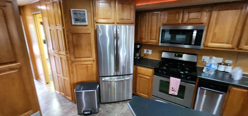 Slide: The Image of Modern kitchen in a 2007 Destination Yachts 16x58 houseboat with stainless steel appliances. - 25