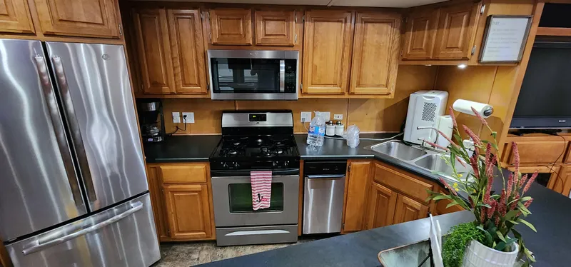 Slide: The Image of Modern kitchen in a 2007 Destination Yachts 16x58 houseboat with stainless steel appliances. - 26