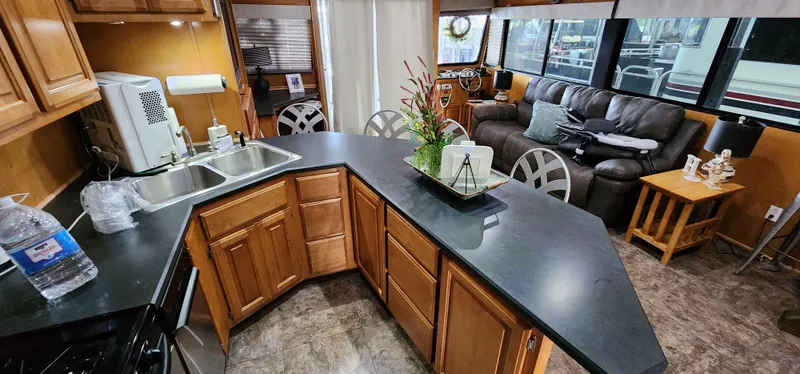 Slide: The Image of 2007 Destination Yachts 16x58 houseboat interior with kitchen and living area. - 27