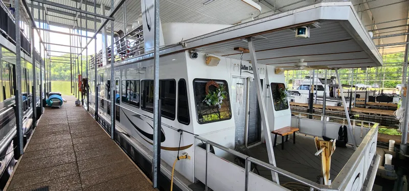 Slide: The Image of 2007 Destination Yachts 16x58 houseboat docked in a covered marina. - 3