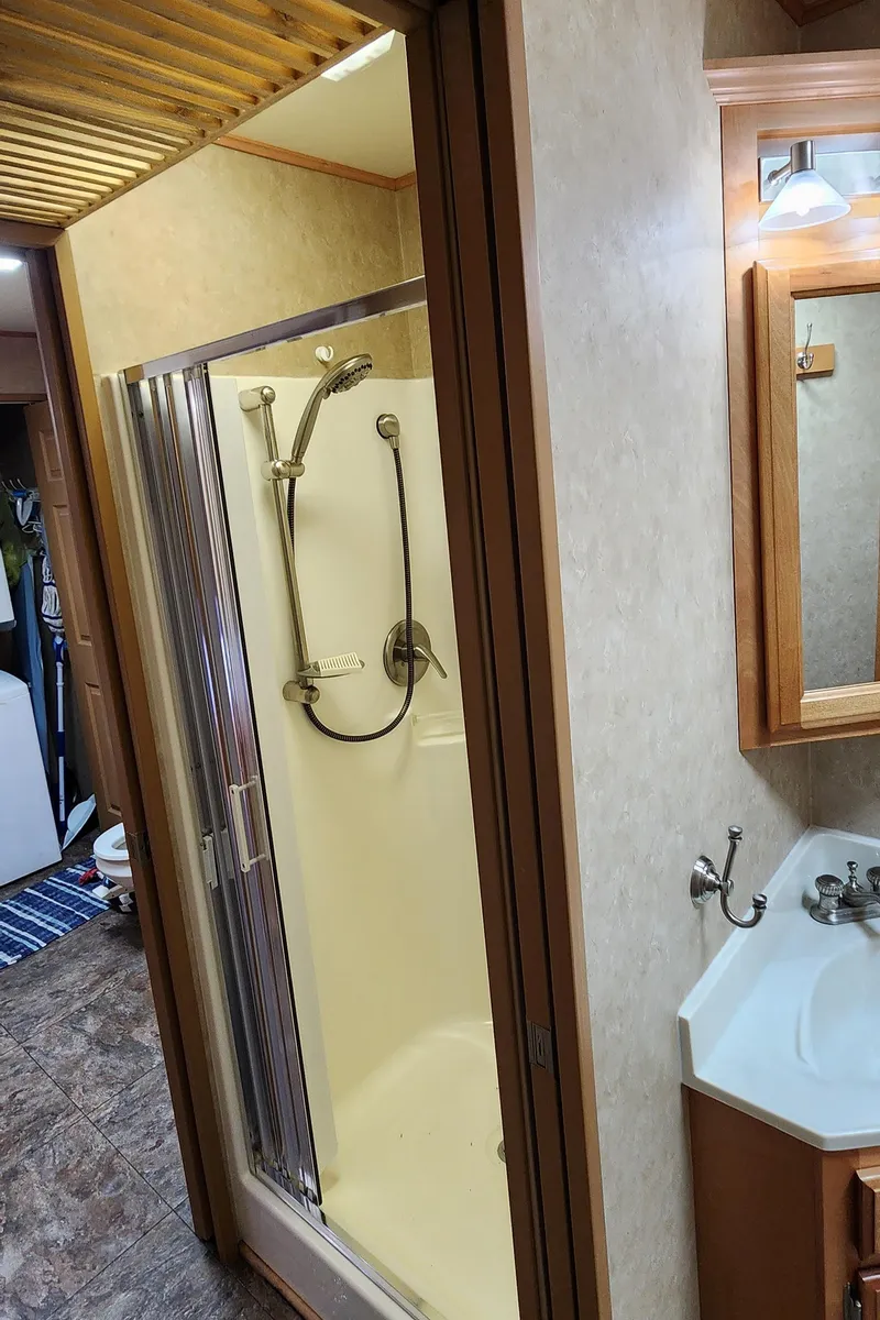 Slide: The Image of 2007 Destination Yachts 16x58 houseboat bathroom with shower and vanity. - 31