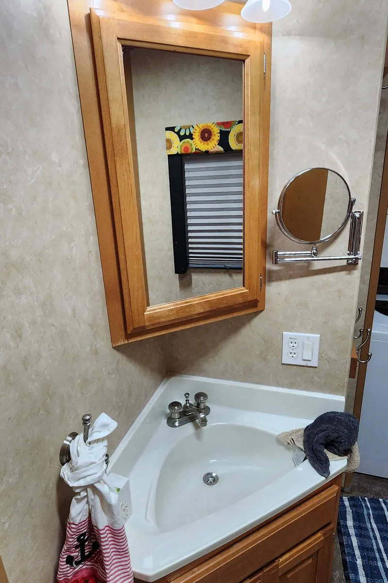 Slide: The Image of Bathroom sink and mirror in a 2007 Destination Yachts 16x58 houseboat. - 35