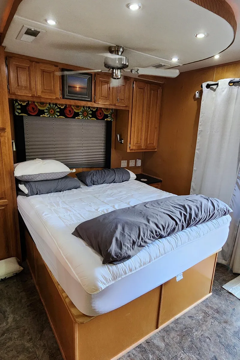 Slide: The Image of Cozy bedroom in a 2007 Destination Yachts 16x58 houseboat with wooden cabinets and modern lighting. - 37