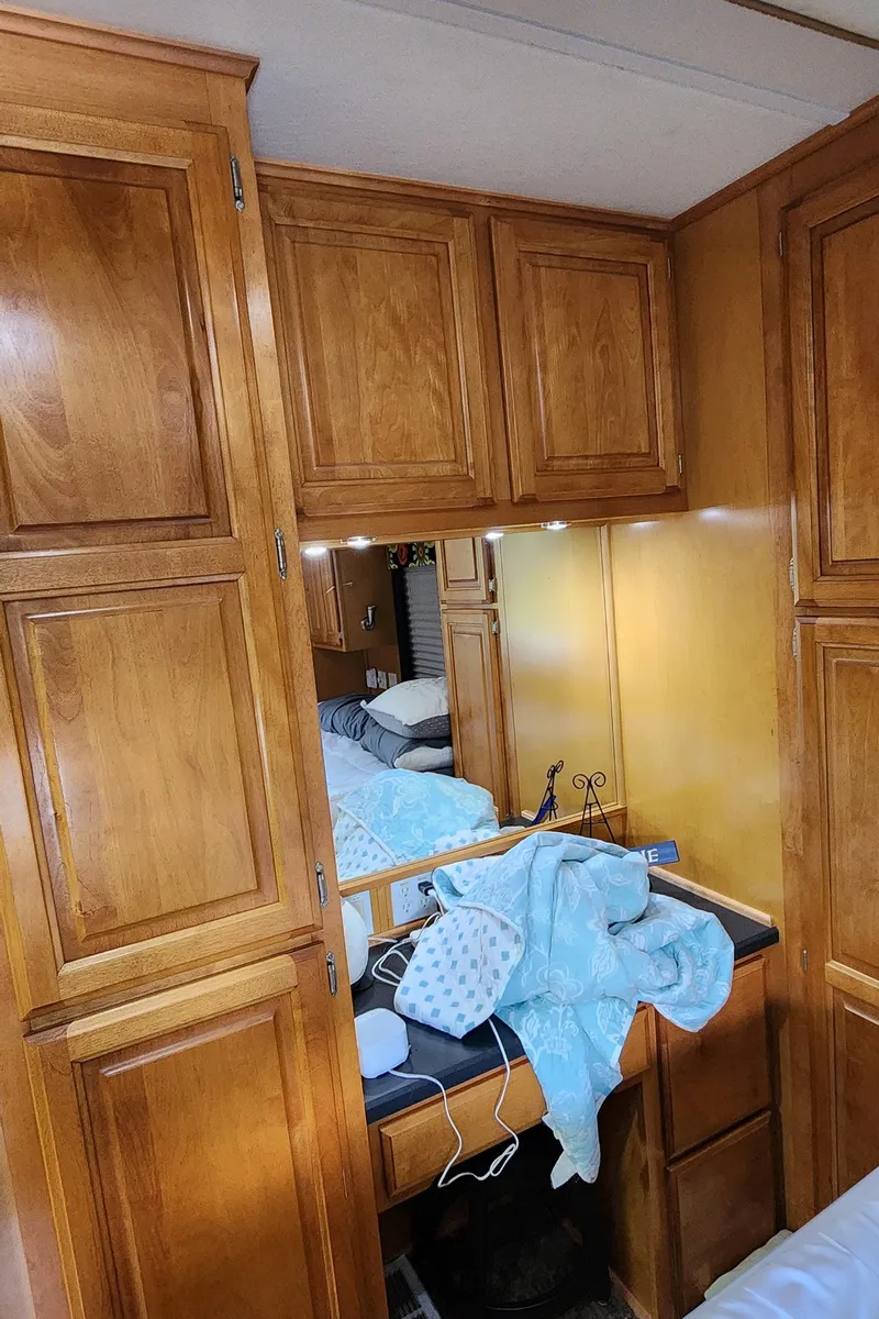 Slide: The Image of Interior of 2007 Destination Yachts 16x58 with wooden cabinets and a small vanity area. - 39