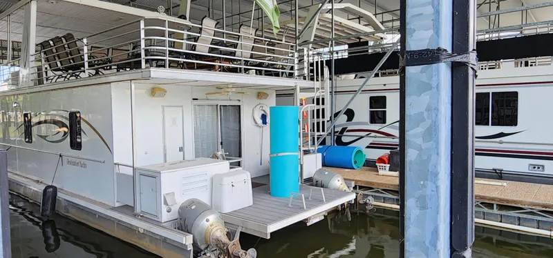 Slide: The Image of 2007 Destination Yachts 16x58 houseboat docked in a marina. - 4