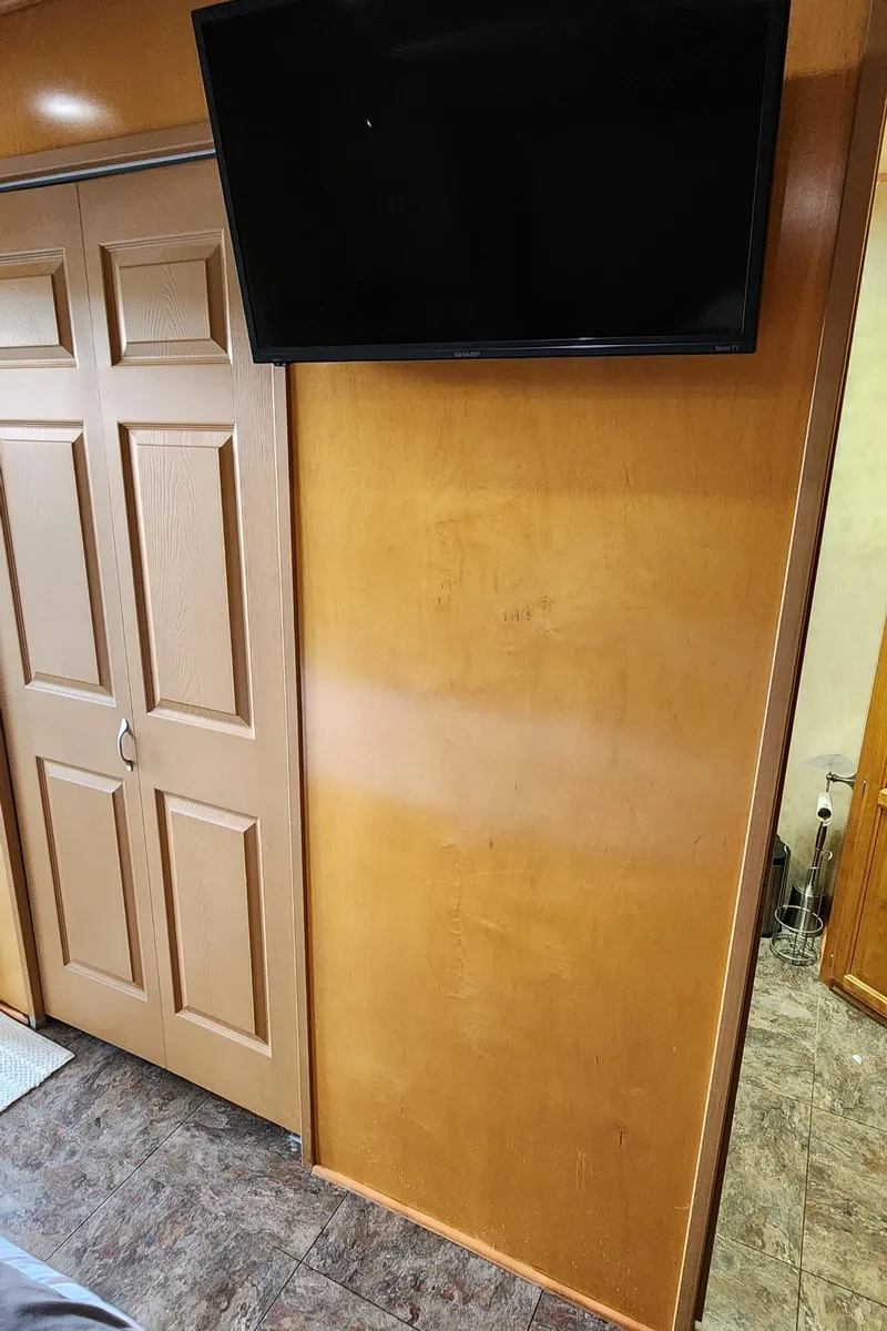 Slide: The Image of Flat-screen TV mounted on wooden wall in 2007 Destination Yachts 16x58 houseboat. - 40