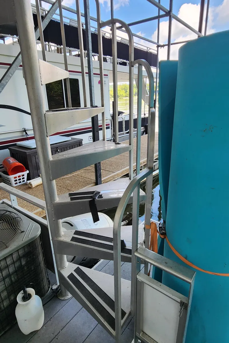 Slide: The Image of 2007 Destination Yachts 16x58 houseboat with spiral staircase and dock view. - 44