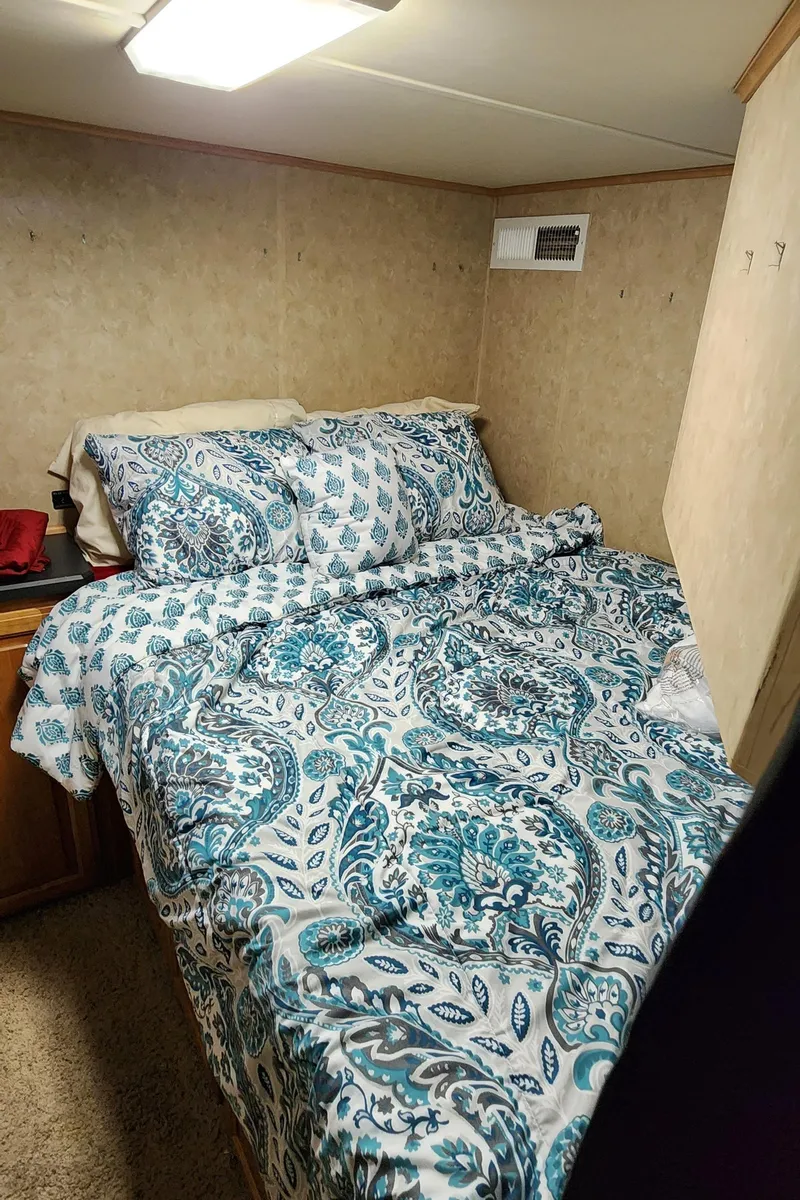 Slide: The Image of Cozy bedroom in 2007 Destination Yachts 16x58 houseboat with patterned bedding. - 48