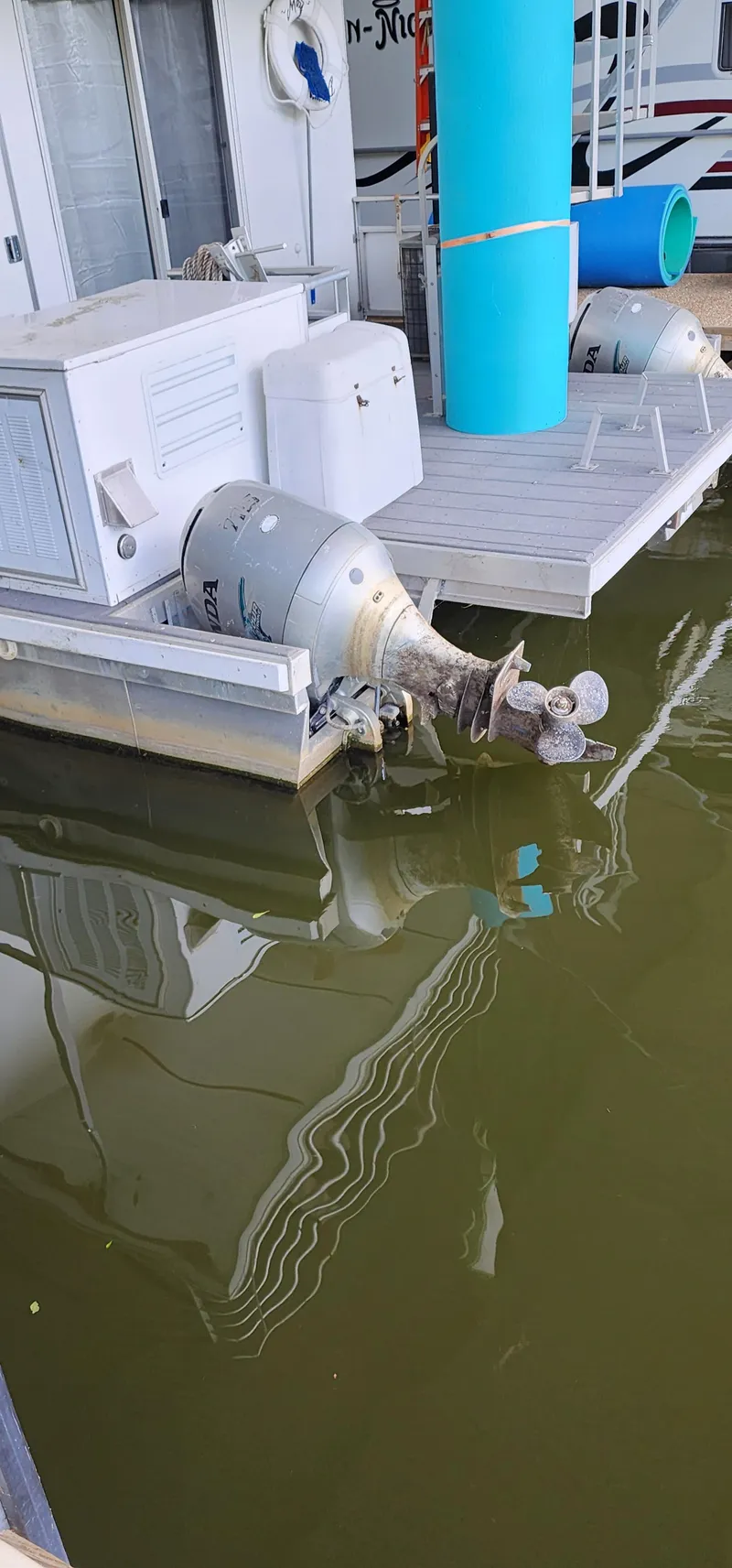Slide: The Image of Outboard motors on a 2007 Destination Yachts 16x58 houseboat docked in water. - 5