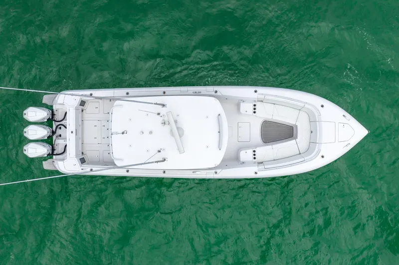 Slide: The Image of Aerial view of a 2022 Intrepid 375 Nomad FE boat on green water. - 11
