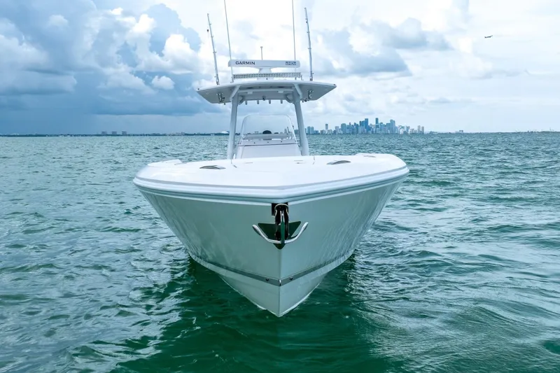 Slide: The Image of 2022 Intrepid 375 Nomad FE boat on open water with city skyline in background. - 13