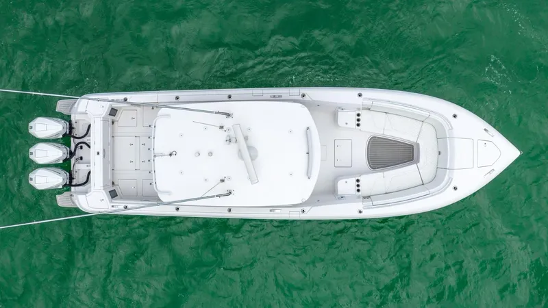 Slide: The Image of Aerial view of a 2022 Intrepid 375 Nomad FE boat on green water. - 14
