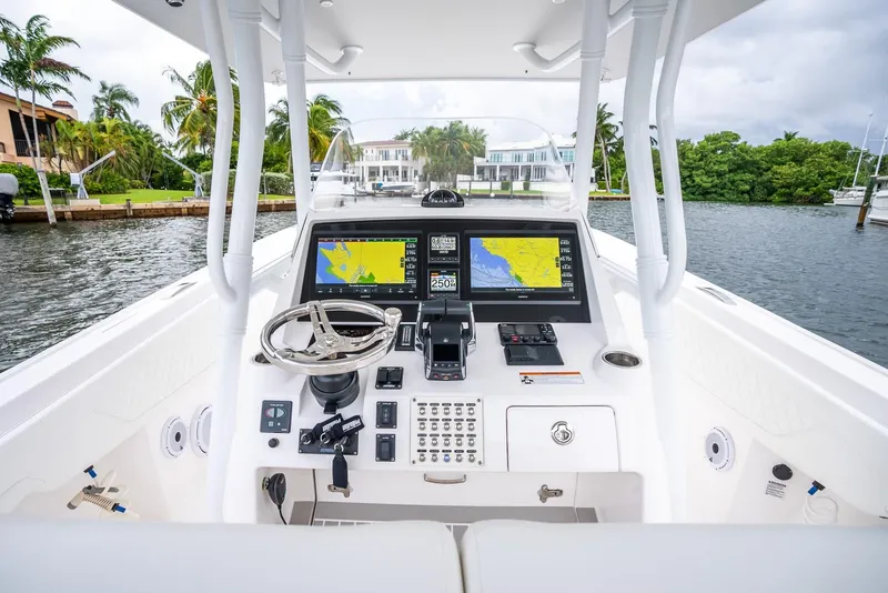 Slide: The Image of 2022 Intrepid 375 Nomad FE boat helm with dual navigation screens. - 16