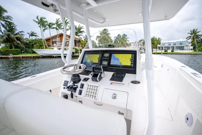 Slide: The Image of 2022 Intrepid 375 Nomad FE boat dashboard with navigation screens and steering wheel. - 17