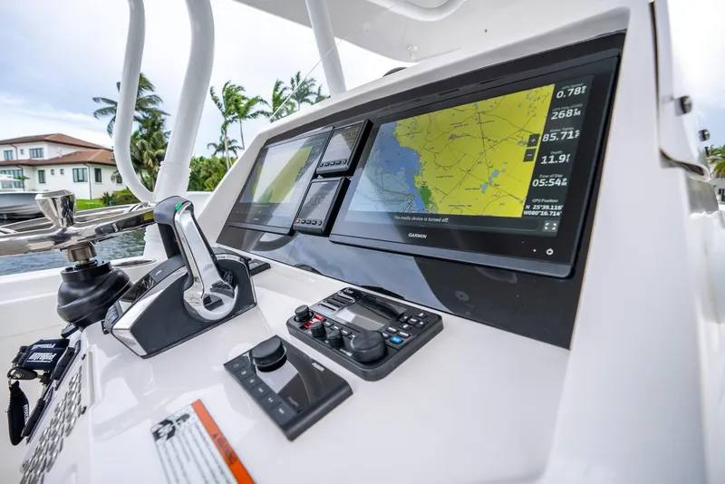 Slide: The Image of 2022 Intrepid 375 Nomad FE boat dashboard with navigation screens and controls. - 18