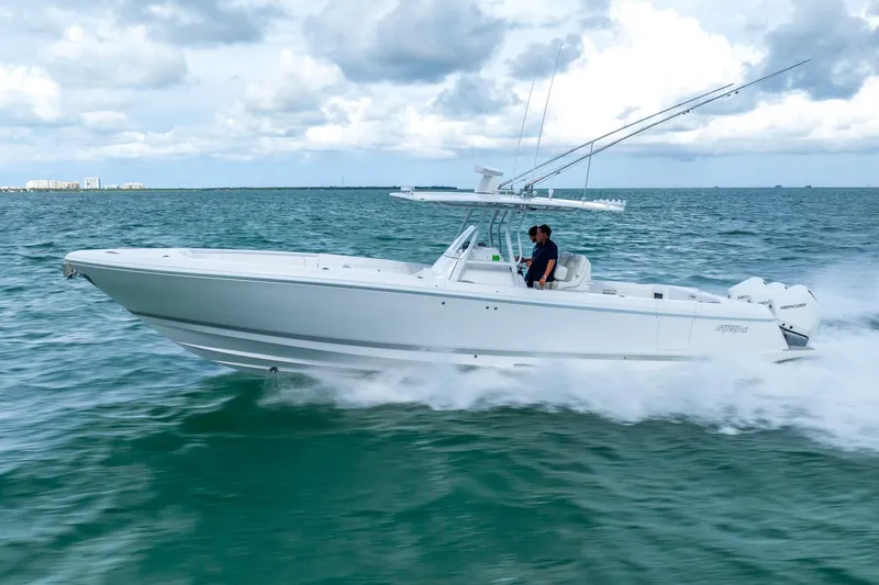 Slide: The Image of 2022 Intrepid 375 Nomad FE boat cruising on open water. - 2