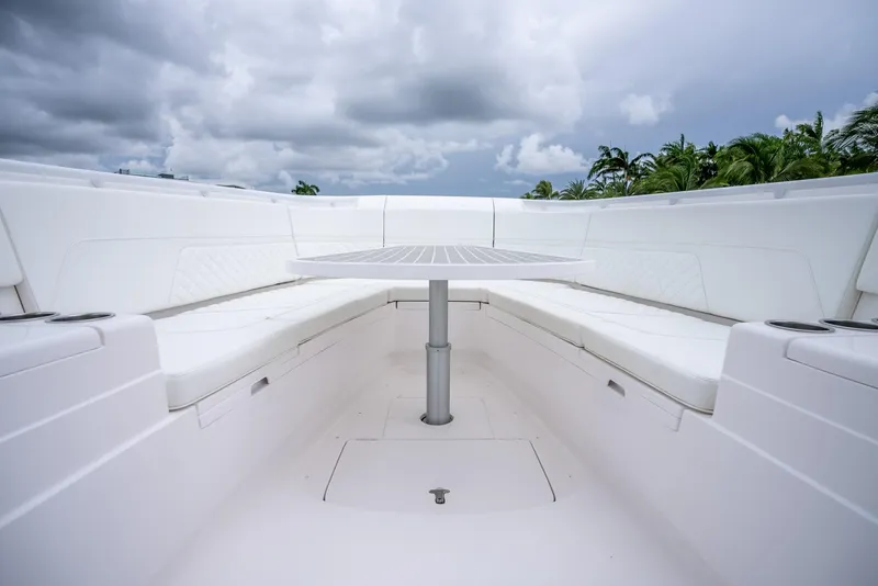 Slide: The Image of 2022 Intrepid 375 Nomad FE boat interior with seating and table. - 21