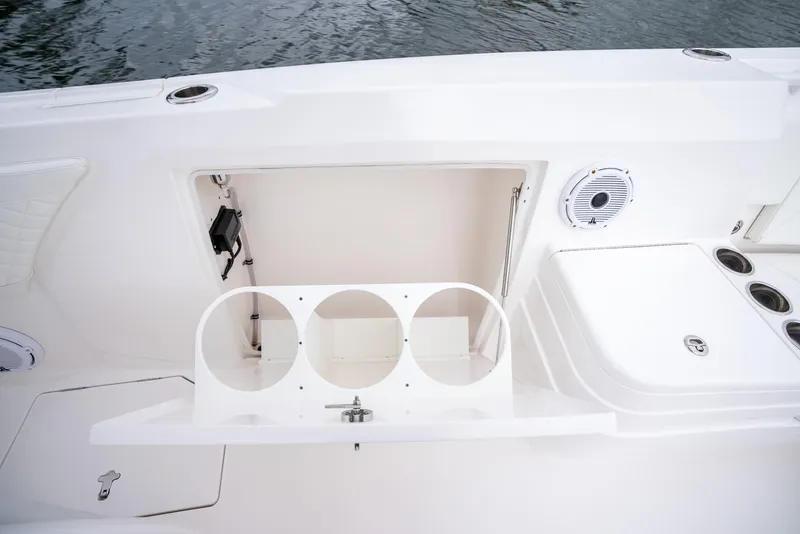 Slide: The Image of 2022 Intrepid 375 Nomad FE boat storage compartment and cup holders. - 29