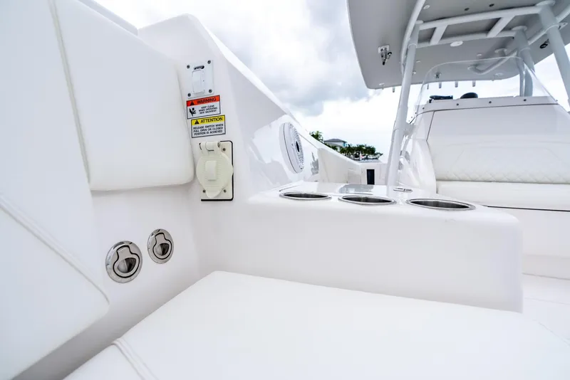 Slide: The Image of 2022 Intrepid 375 Nomad FE boat interior with cup holders and seating. - 32