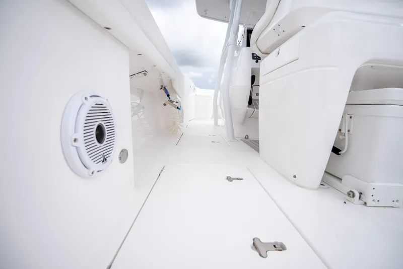 Slide: The Image of 2022 Intrepid 375 Nomad FE boat interior, white deck and seating area. - 33