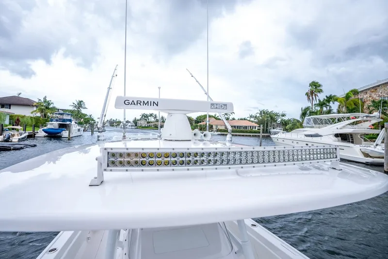 Slide: The Image of 2022 Intrepid 375 Nomad FE boat with Garmin radar on a marina. - 34