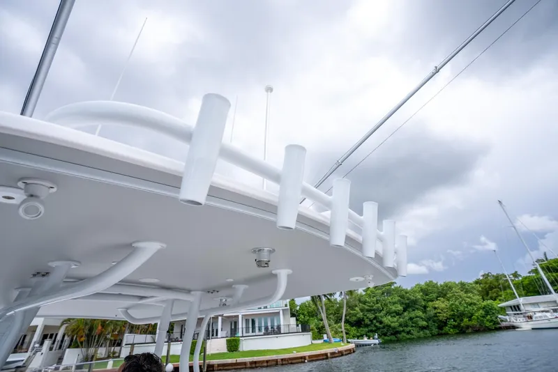 Slide: The Image of 2022 Intrepid 375 Nomad FE boat with rod holders, docked near waterfront homes. - 41