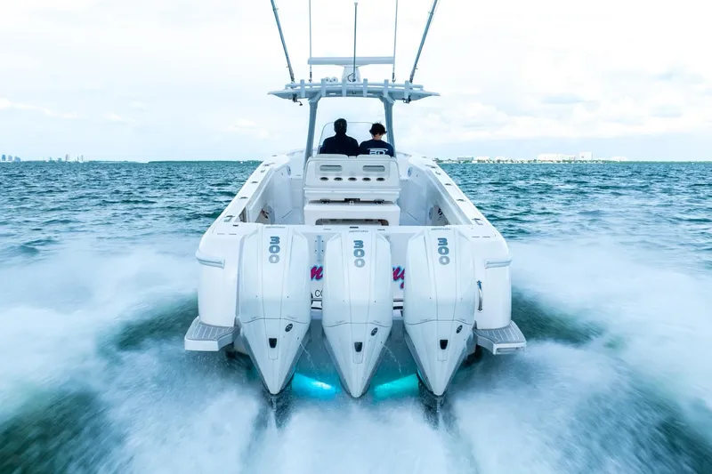 Slide: The Image of 2022 Intrepid 375 Nomad FE boat speeding on water, rear view. - 6
