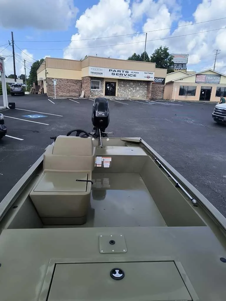 Slide: The Image of 2024 Tracker Grizzly 1648 SC boat in parking lot near service center. - 4