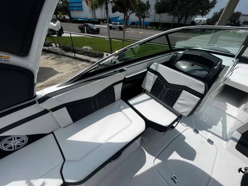 Slide: The Image of 2024 Monterey 275 Super Sport boat interior with white and black seating. - 11