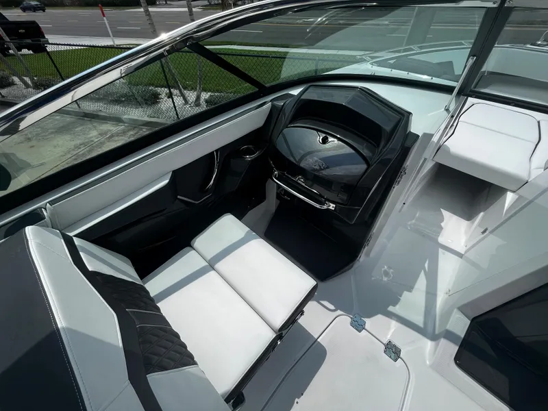 Slide: The Image of 2024 Monterey 275 Super Sport boat interior with modern dashboard and seating. - 12