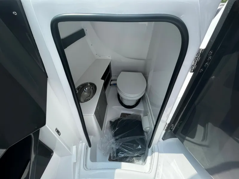 Slide: The Image of 2024 Monterey 275 Super Sport boat interior bathroom with toilet and sink. - 13