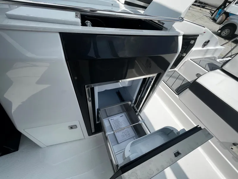 Slide: The Image of 2024 Monterey 275 Super Sport boat interior with open storage compartments. - 15