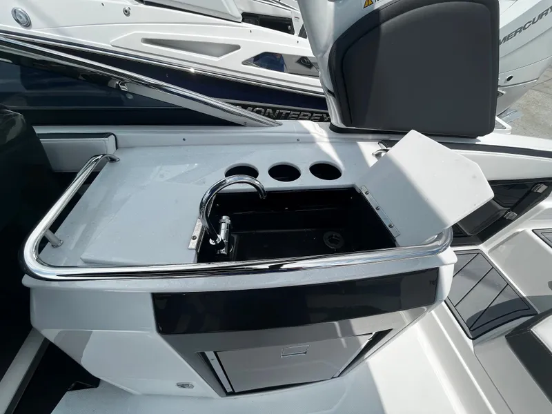 Slide: The Image of 2024 Monterey 275 Super Sport boat interior with sink and storage. - 16