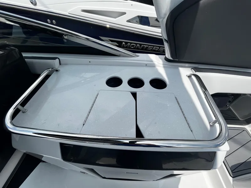 Slide: The Image of 2024 Monterey 275 Super Sport boat with sleek white deck and cup holders. - 18