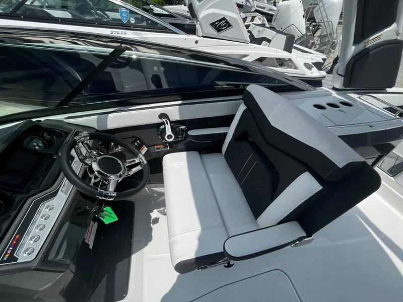 Slide: The Image of 2024 Monterey 275 Super Sport boat cockpit with modern steering wheel and comfortable seating. - 19